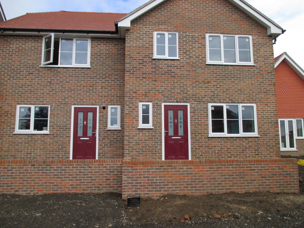 Pair of new build red brick semi-detached houses