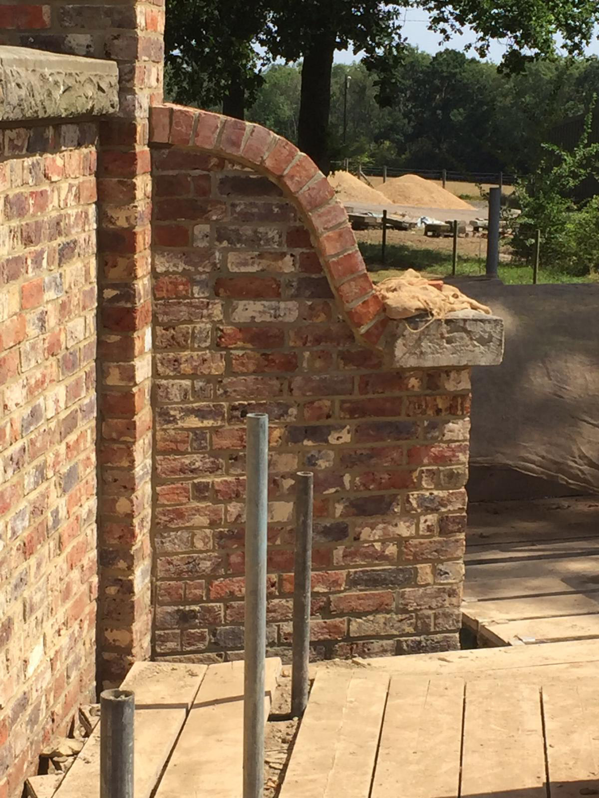 Curved brick garden wall beside timber steps