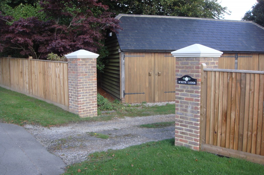 Pair of brick pillars with stone caps at a driveway entrance