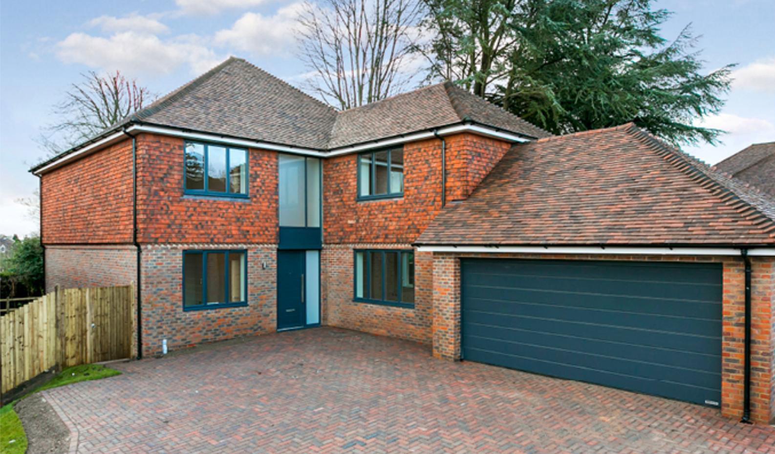 Detached red brick new build house with a block-paved driveway